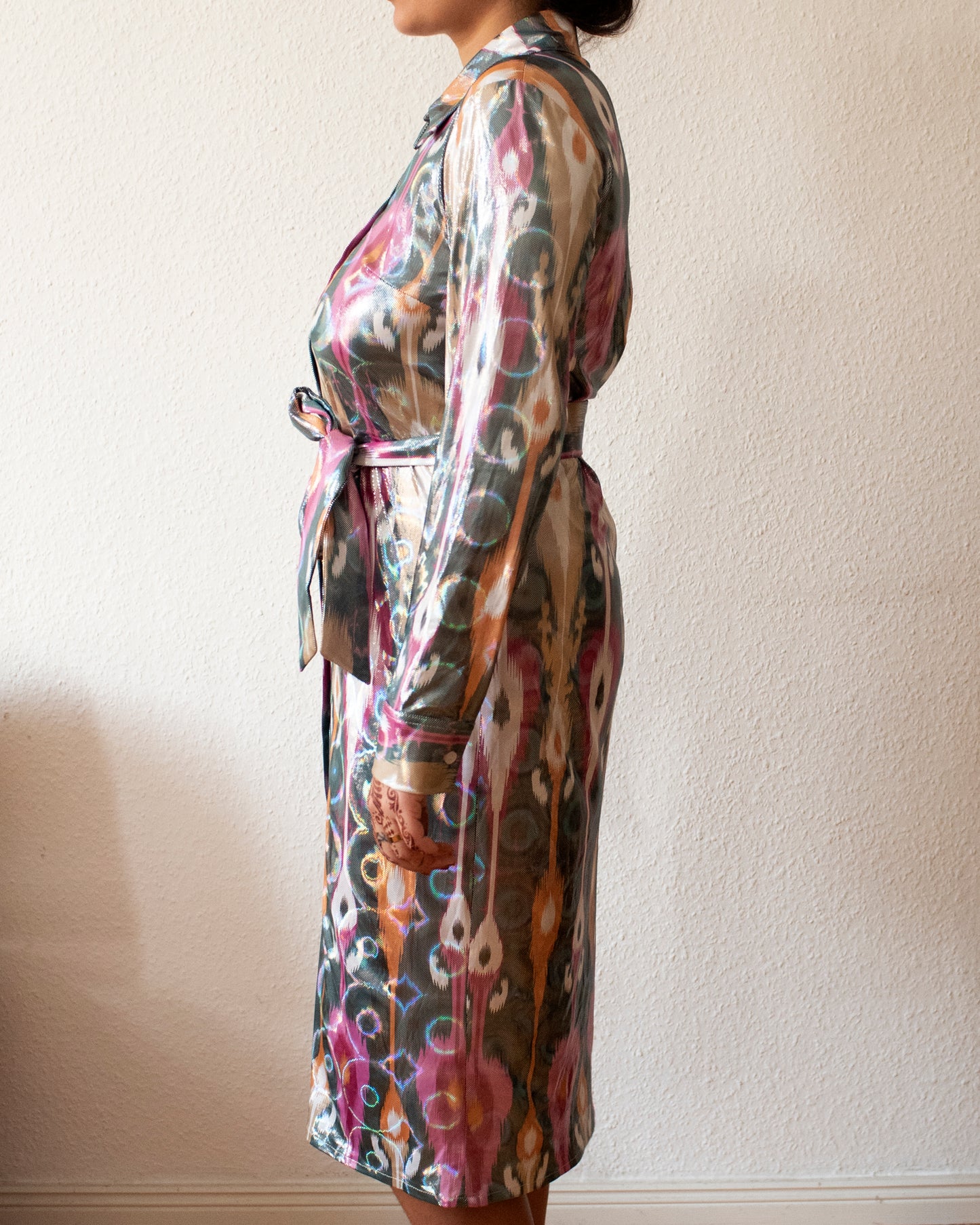 Profile of a woman's body with a wrap dress on.