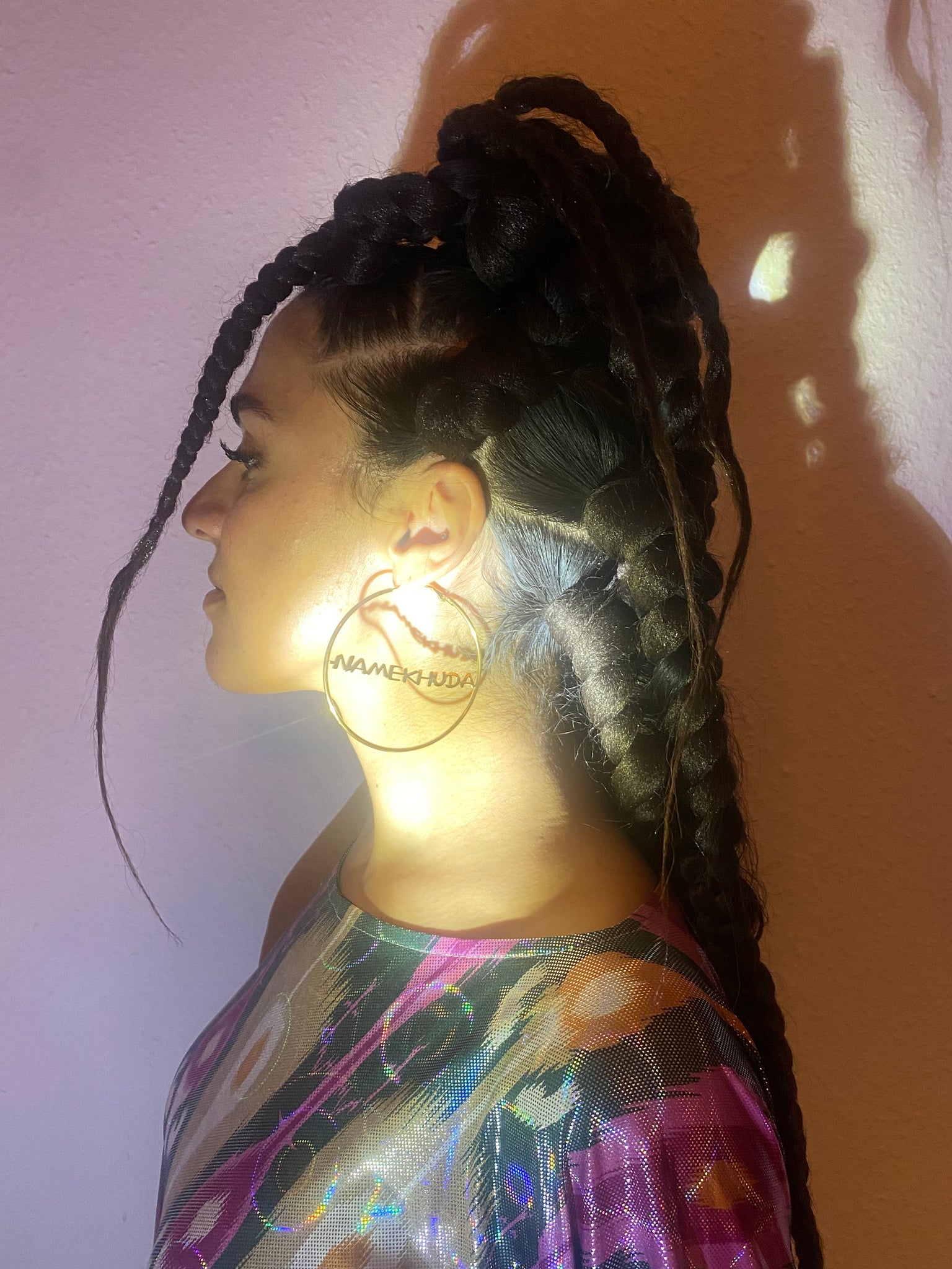 A woman's profile showing her wearing big gold hoops.