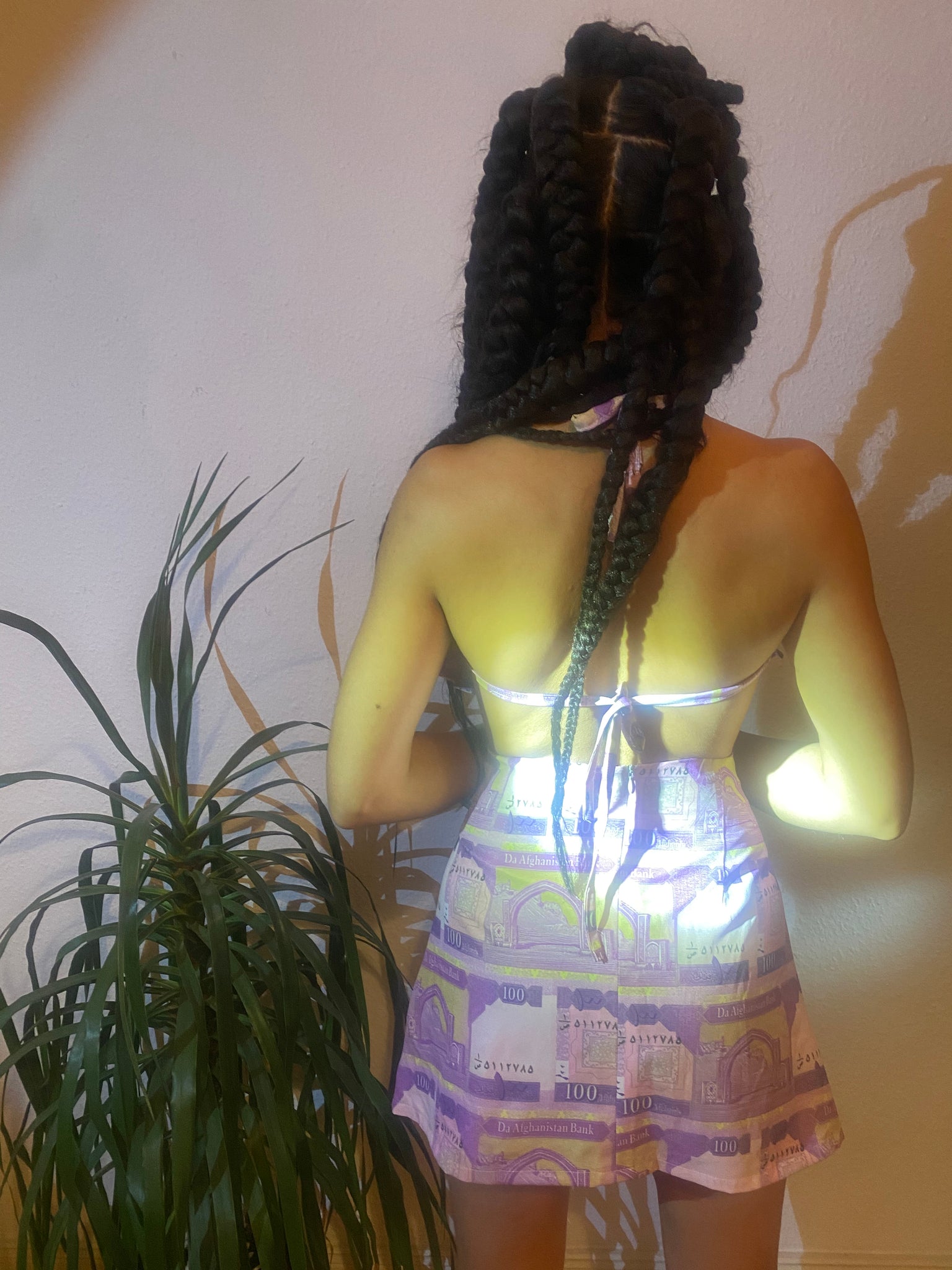 A woman's back showing the tie closure of her halter top.