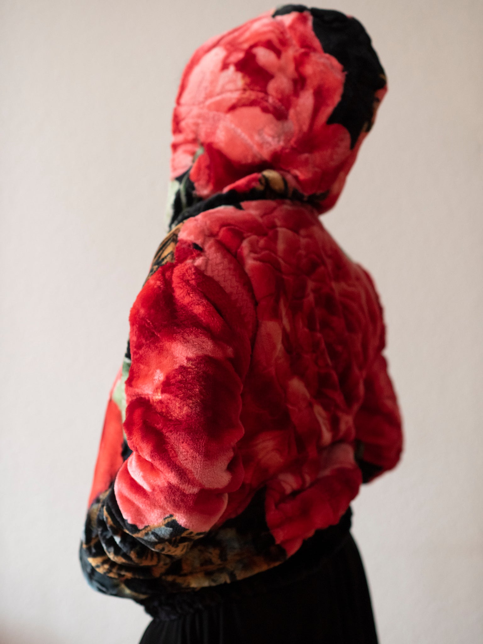 Back of a woman wearing a kampal jacket in black and red.