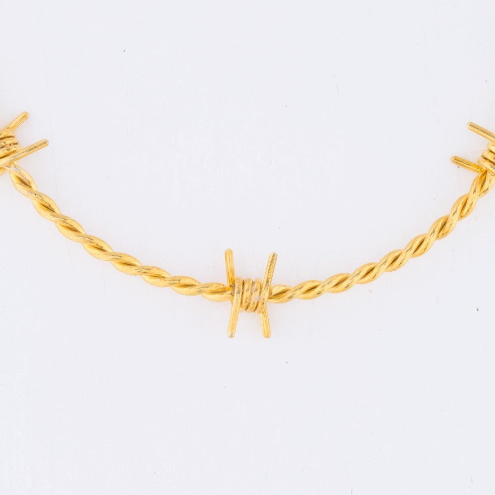 The Kabul House Essential Barb Wire Choker - Blingistan, close up of gold plated barbwire necklace.
